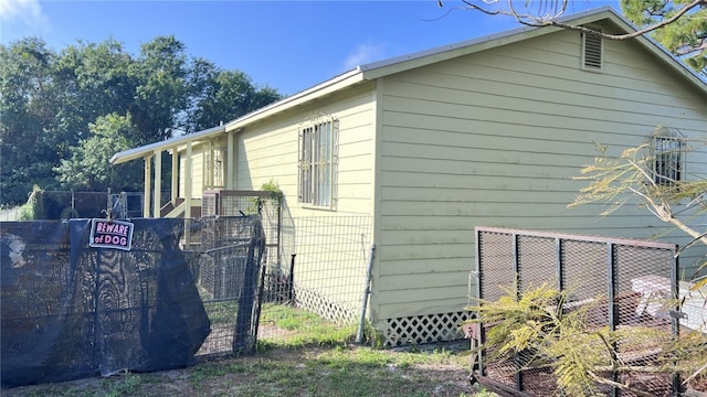 view of side of property featuring fence