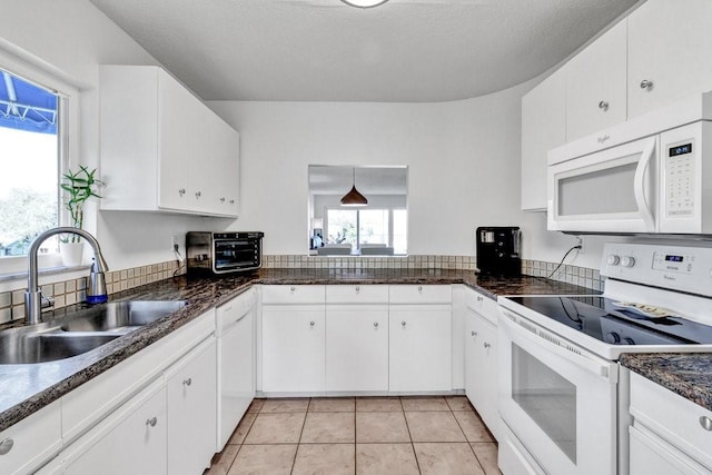 kitchen with sink, white cabinets, and white appliances