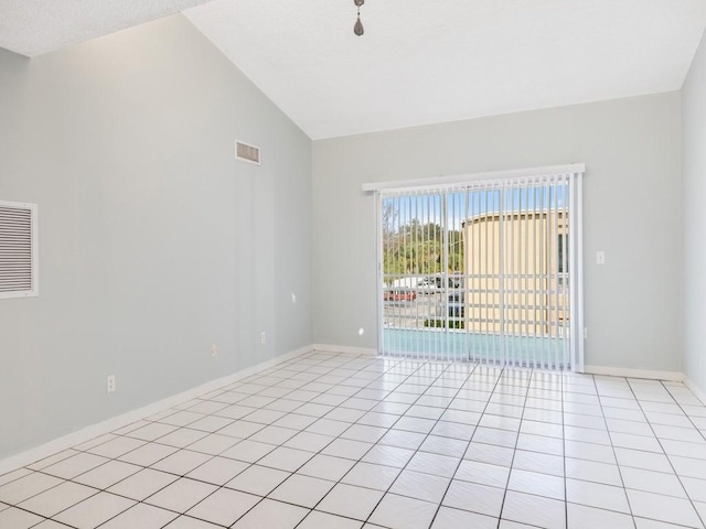 unfurnished room with light tile patterned flooring and high vaulted ceiling