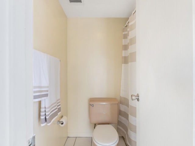 bathroom featuring toilet and tile patterned flooring