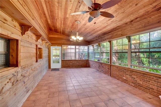 unfurnished sunroom featuring ceiling fan with notable chandelier, wood ceiling, and vaulted ceiling