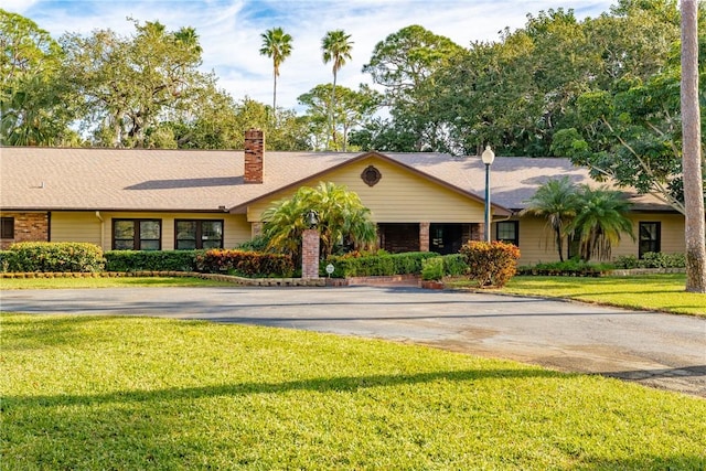 ranch-style house with a front lawn