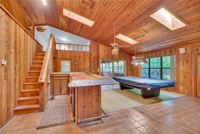 recreation room with wooden ceiling, lofted ceiling with skylight, wooden walls, ceiling fan, and pool table