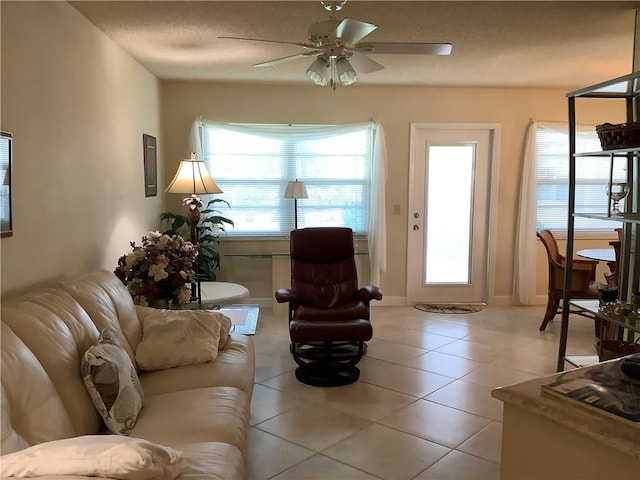 4 Vista Gardens Trl Unit 103, Vero Beach, FL 32962 - living room featuring a ceiling fan, light tile patterned floors, and a textured ceiling