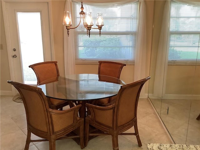 4 Vista Gardens Trl Unit 103, Vero Beach, FL 32962 - dining space featuring a chandelier and light tile patterned floors