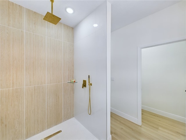 bathroom with a shower and wood-type flooring