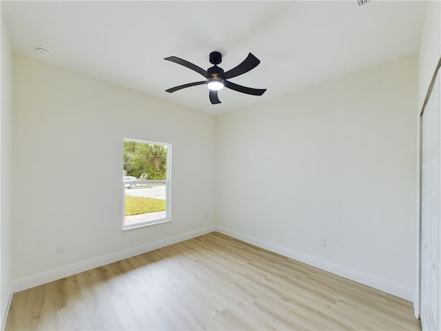 empty room with ceiling fan and light hardwood / wood-style floors