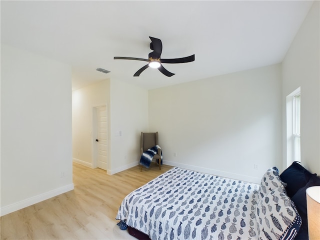 bedroom with ceiling fan and light hardwood / wood-style floors