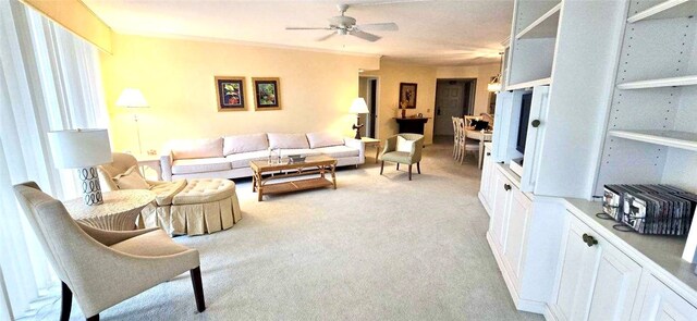 living room with plenty of natural light, ceiling fan, and light colored carpet