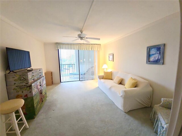 carpeted living room featuring ceiling fan and ornamental molding