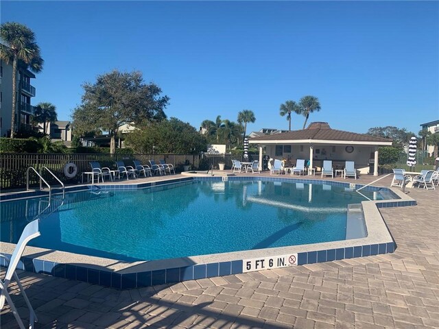 view of pool featuring a community hot tub and a patio area