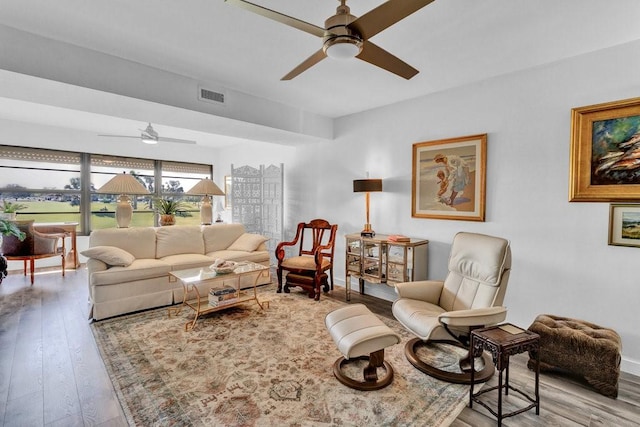 living room featuring light hardwood / wood-style floors and ceiling fan