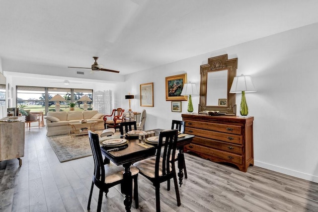 dining space with ceiling fan and light wood-type flooring