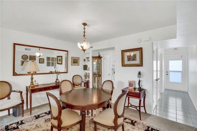 tiled dining space featuring visible vents