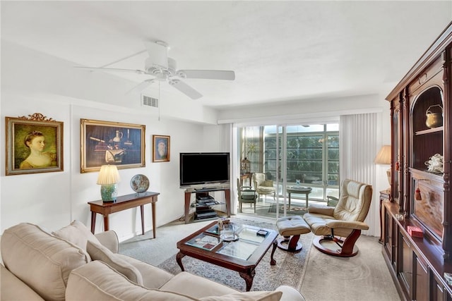 living room featuring light carpet, visible vents, and a ceiling fan