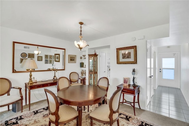 tiled dining area featuring visible vents