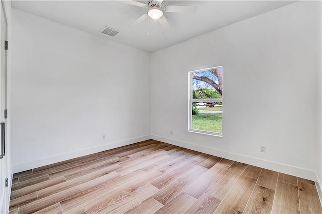 unfurnished room with ceiling fan, visible vents, baseboards, and light wood-style flooring