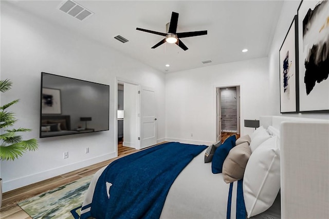 bedroom with recessed lighting, visible vents, baseboards, and wood finished floors