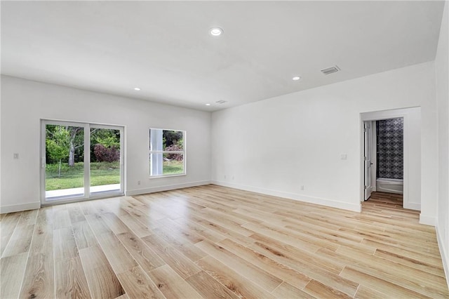 empty room with visible vents, recessed lighting, baseboards, and light wood-style floors