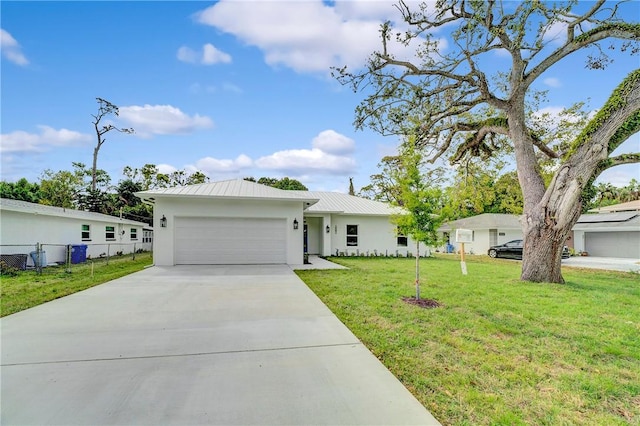 single story home featuring stucco siding, a garage, a front lawn, concrete driveway, and metal roof