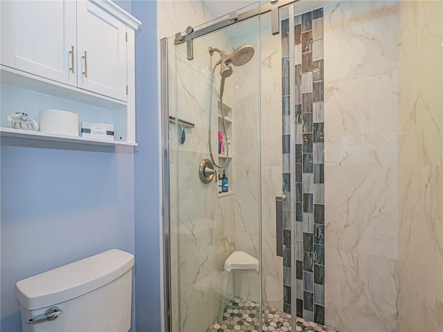 bathroom featuring walk in shower and toilet