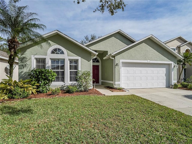 view of front of home featuring a garage and a front yard