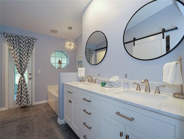 bathroom featuring an inviting chandelier, vanity, and a washtub