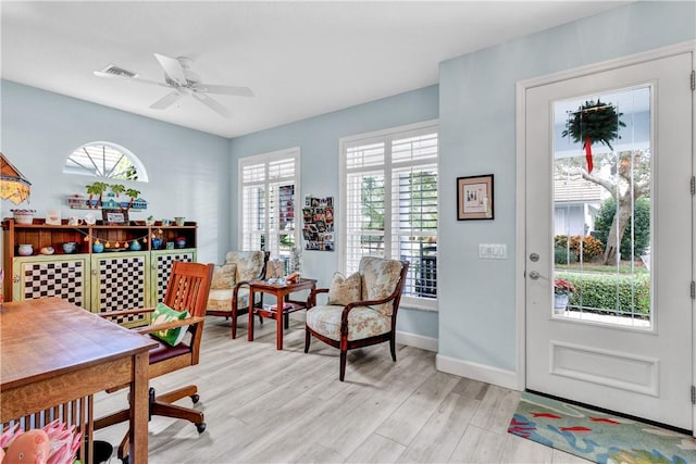 office with ceiling fan and light hardwood / wood-style floors