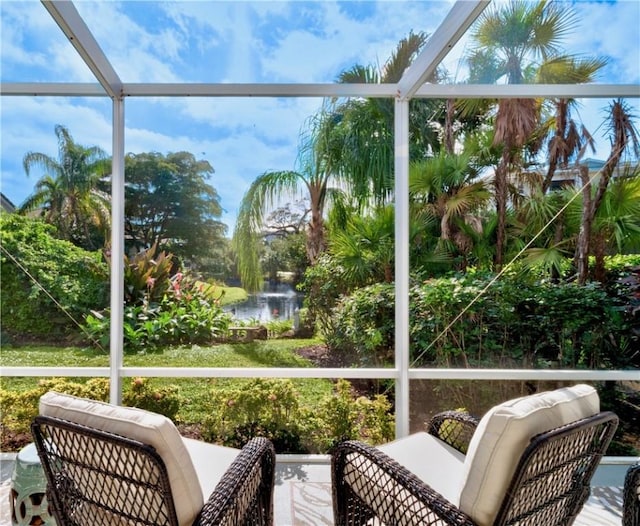 sunroom / solarium featuring a water view