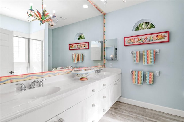 bathroom with vanity and a shower with door