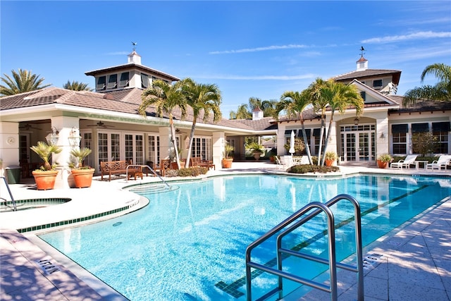 community pool with a ceiling fan, french doors, and a patio