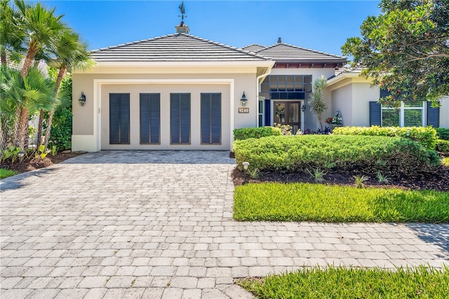 view of front of house featuring a tiled roof and stucco siding