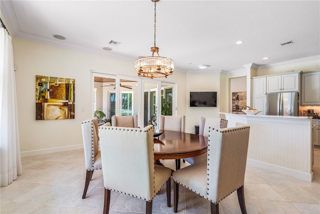 dining room featuring baseboards, visible vents, a notable chandelier, and ornamental molding