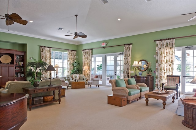 living room with light carpet, visible vents, a ceiling fan, crown molding, and french doors