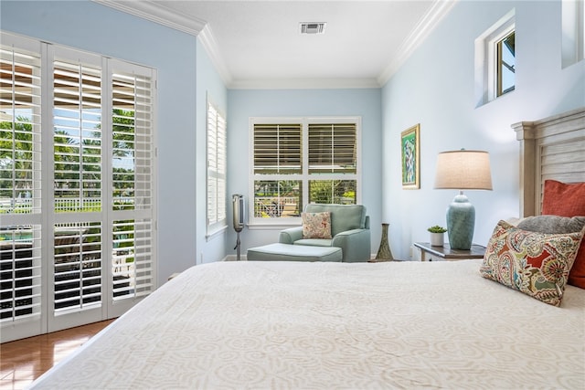 bedroom with access to outside, visible vents, and crown molding