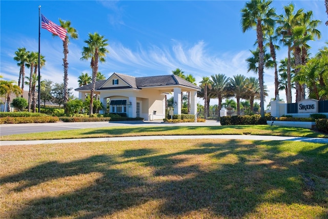 view of front of property with a tile roof and a front lawn