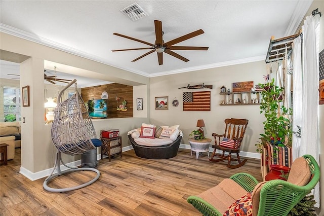 7720 15th Ln, Vero Beach, FL 32966 - living area featuring baseboards, visible vents, wood finished floors, ceiling fan, and crown molding