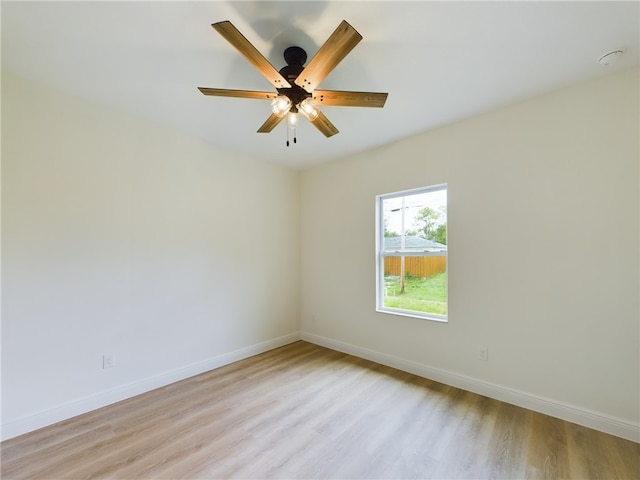 spare room with light wood-type flooring and ceiling fan