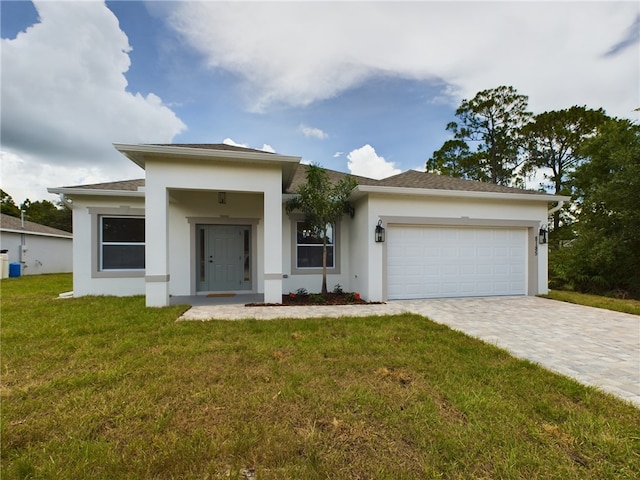 view of front of home with a front lawn and a garage