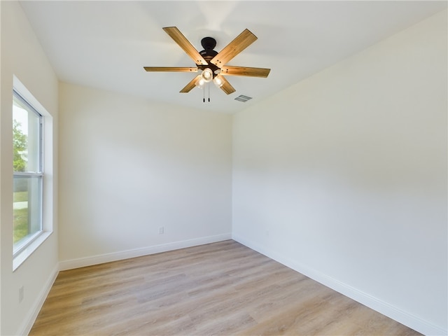 empty room featuring ceiling fan and light wood-type flooring