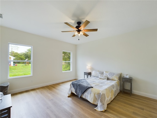 bedroom with hardwood / wood-style floors and ceiling fan