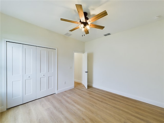 unfurnished bedroom featuring a closet, ceiling fan, and light hardwood / wood-style flooring