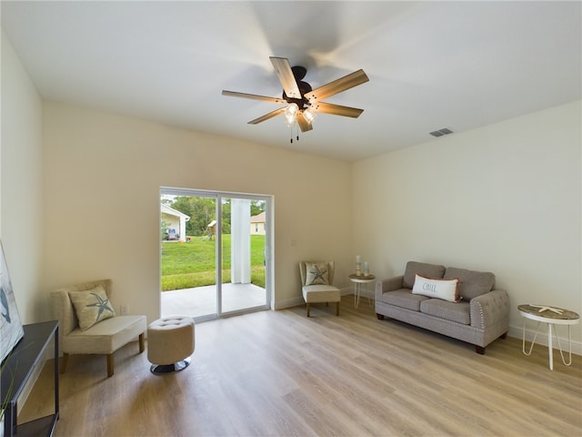 living area featuring light hardwood / wood-style floors and ceiling fan