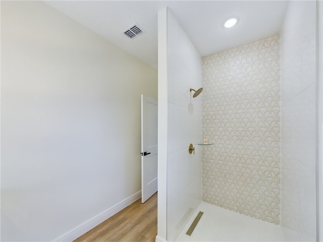 bathroom with walk in shower and hardwood / wood-style flooring