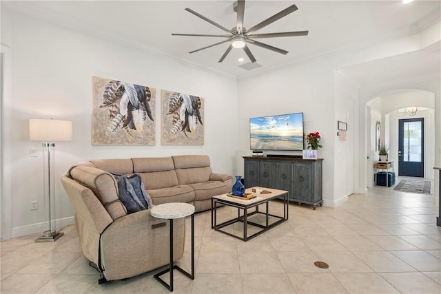 tiled living room featuring ceiling fan and ornamental molding