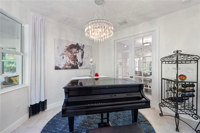 misc room with french doors, light tile patterned floors, and an inviting chandelier