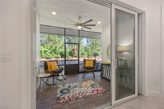 interior space with ceiling fan