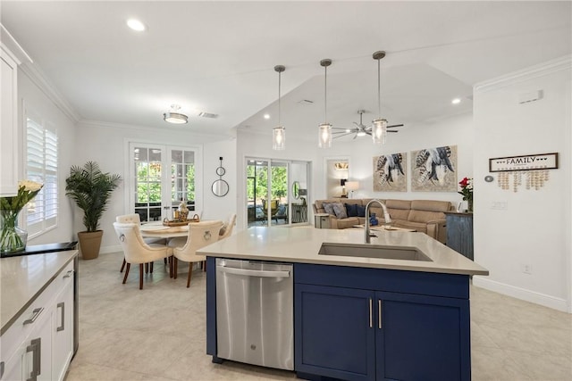 kitchen with stainless steel dishwasher, sink, decorative light fixtures, white cabinetry, and an island with sink