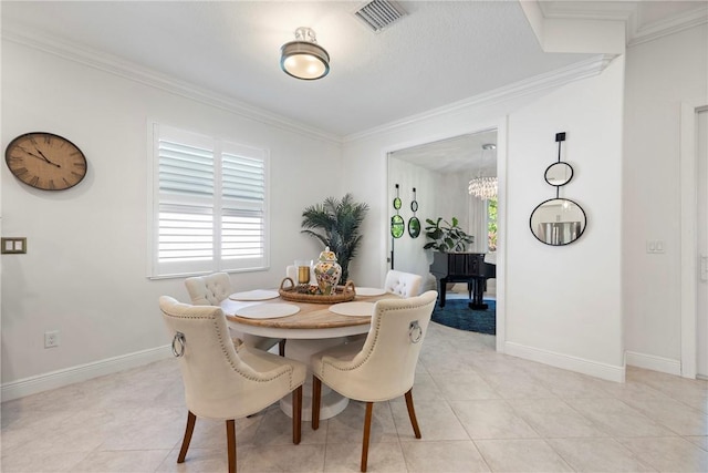 dining room with an inviting chandelier, ornamental molding, and light tile patterned flooring