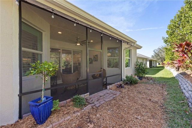 doorway to property with ceiling fan